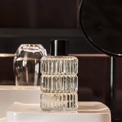 Un flacon d'eau de Cologne posé sur une étagère en bois minimaliste