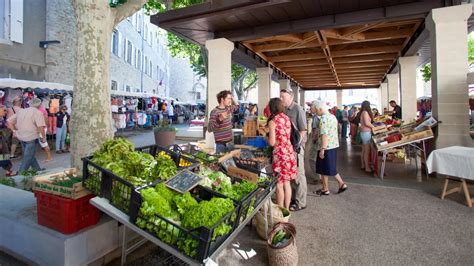 Jeune maraîcher expliquant sa production à des clients sur un marché local de Strasbourg