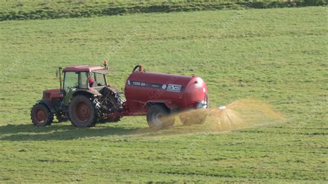 Tractor spreading slurry in a field