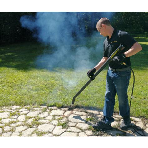 Image of a thermal weed killer in action on a patio