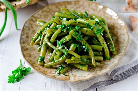 Plat de haricots verts cuisinés avec des herbes aromatiques