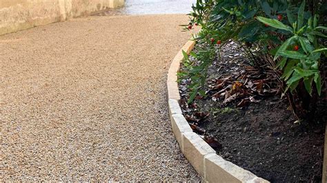 Schéma technique illustrant l'installation de bordures en pierre naturelle le long d'une allée de jardin