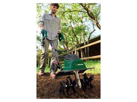 Jardinier utilisant une bineuse électrique dans un potager
