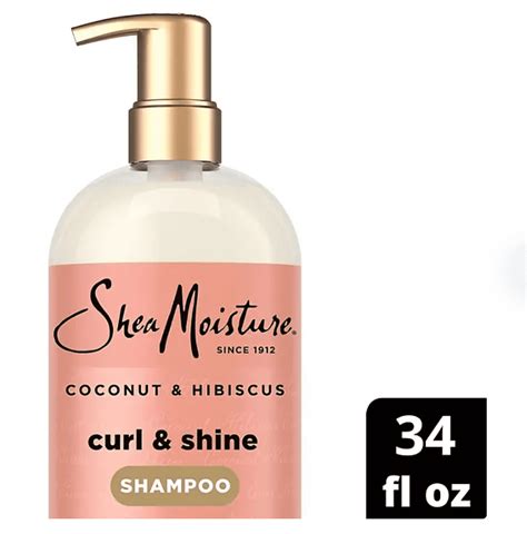 Bouteille de mousse SheaMoisture Coconut & Hibiscus avec des ingrédients naturels autour