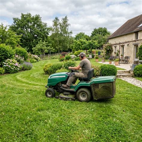 Tracteur tondeuse en action sur une grande pelouse résidentielle