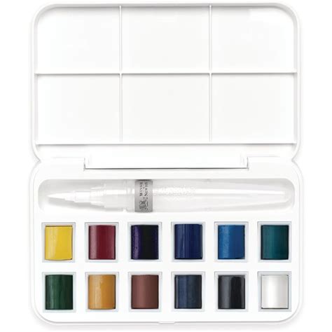 Palette d'aquarelle avec des demi-godets remplis de peinture colorée