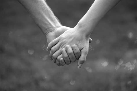 Couple se regardant avec intensité, main dans la main