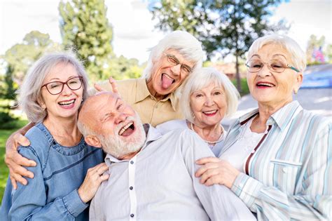Photo d'un groupe de personnes âgées jardinant ensemble dans des bacs surélevés
