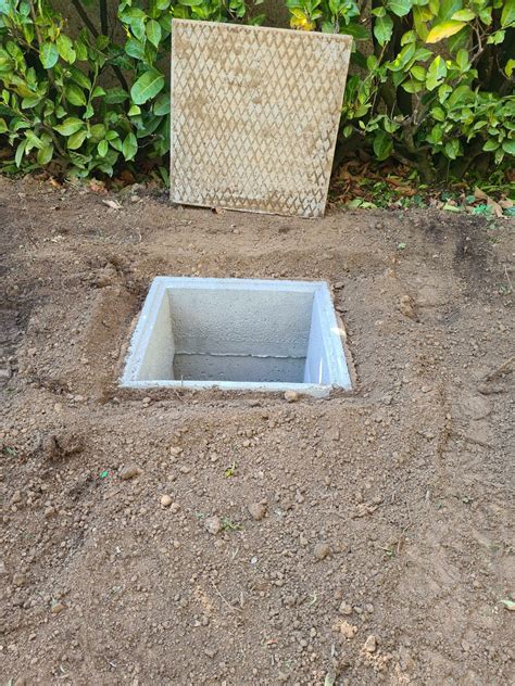 Schéma technique d'un regard de vannes enterré dans un jardin
