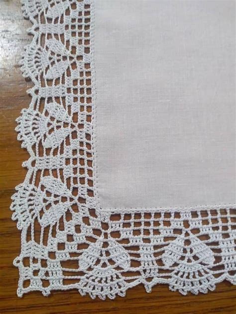 Exemple de bordure de nappe ornée de palmettes lotus en broderie ajourée