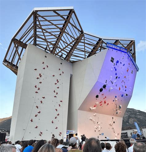 structure de jeu combinant toboggan et mur d'escalade en milieu extérieur