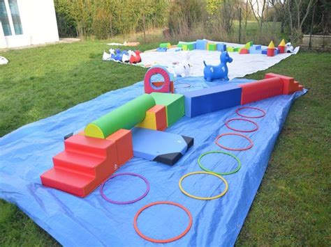 Enfant explorant un parcours de motricité fait maison avec des coussins et des chaises