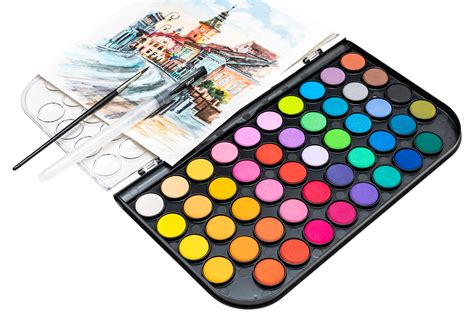 une palette de couleurs vibrantes et des pinceaux posés sur une toile vierge